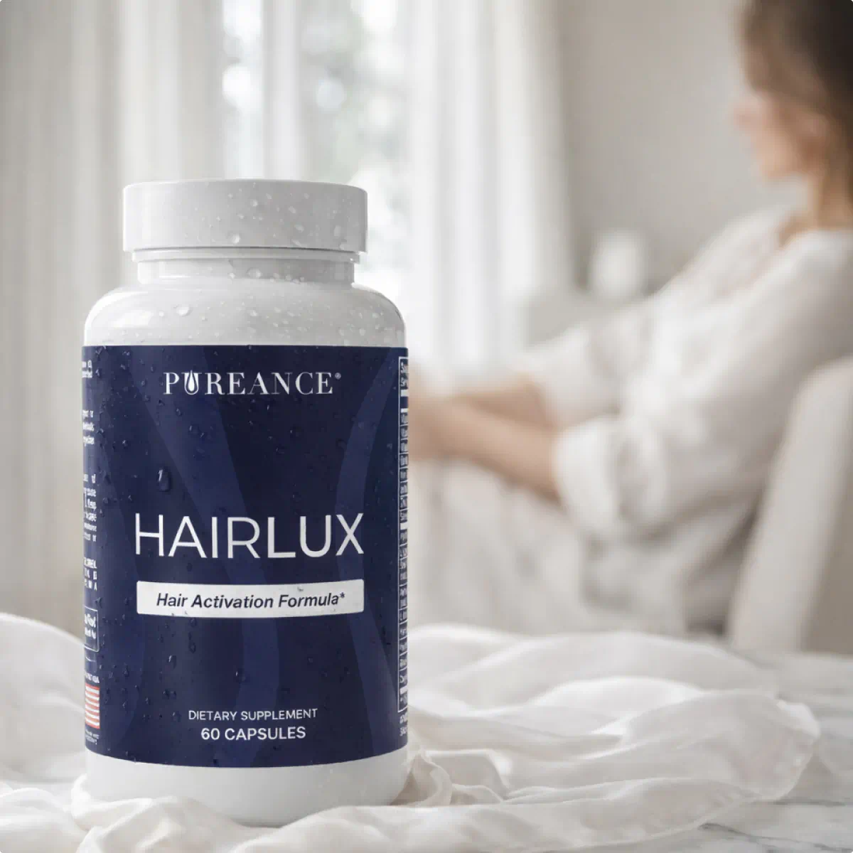 HairLux bottle on bed with woman in soft-focus background