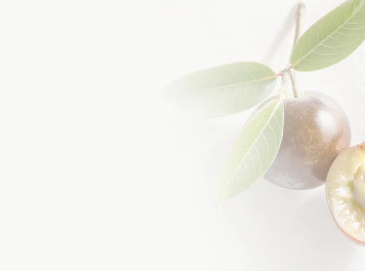 Whole and halved Camu Camu berries with green leaves